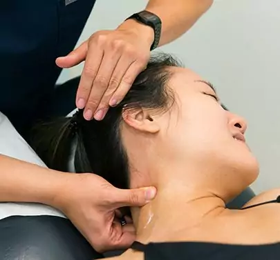 chiropractor examining patients neck