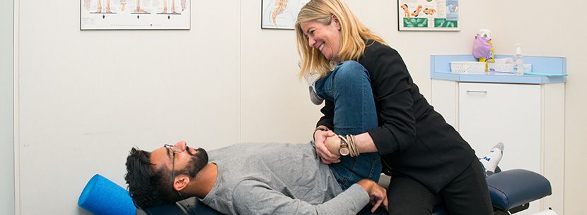physiotherapist treating patient with hip pain
